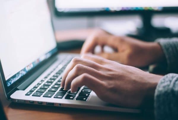 Person typing on a laptop keyboard