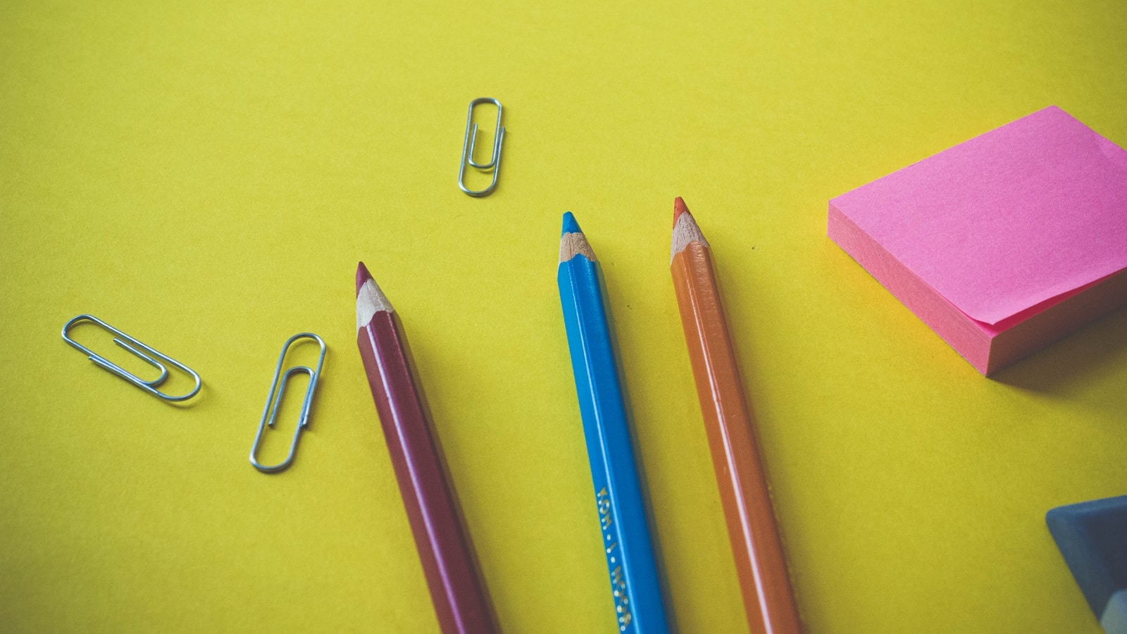 Colored pencils on green and yellow table