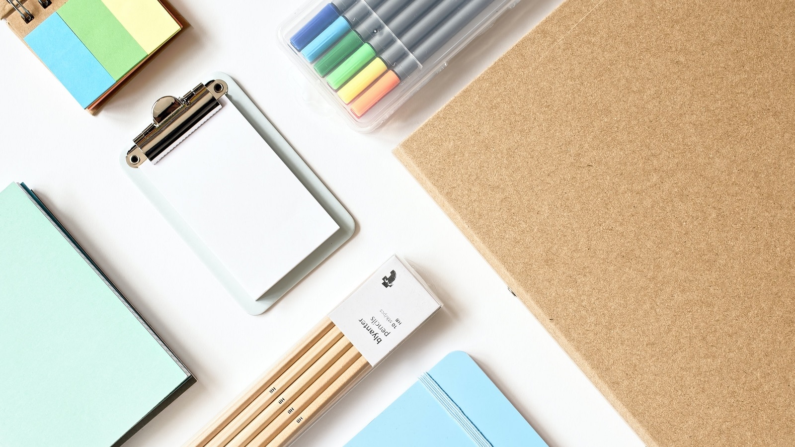 Pastel colored school supplies on a white table