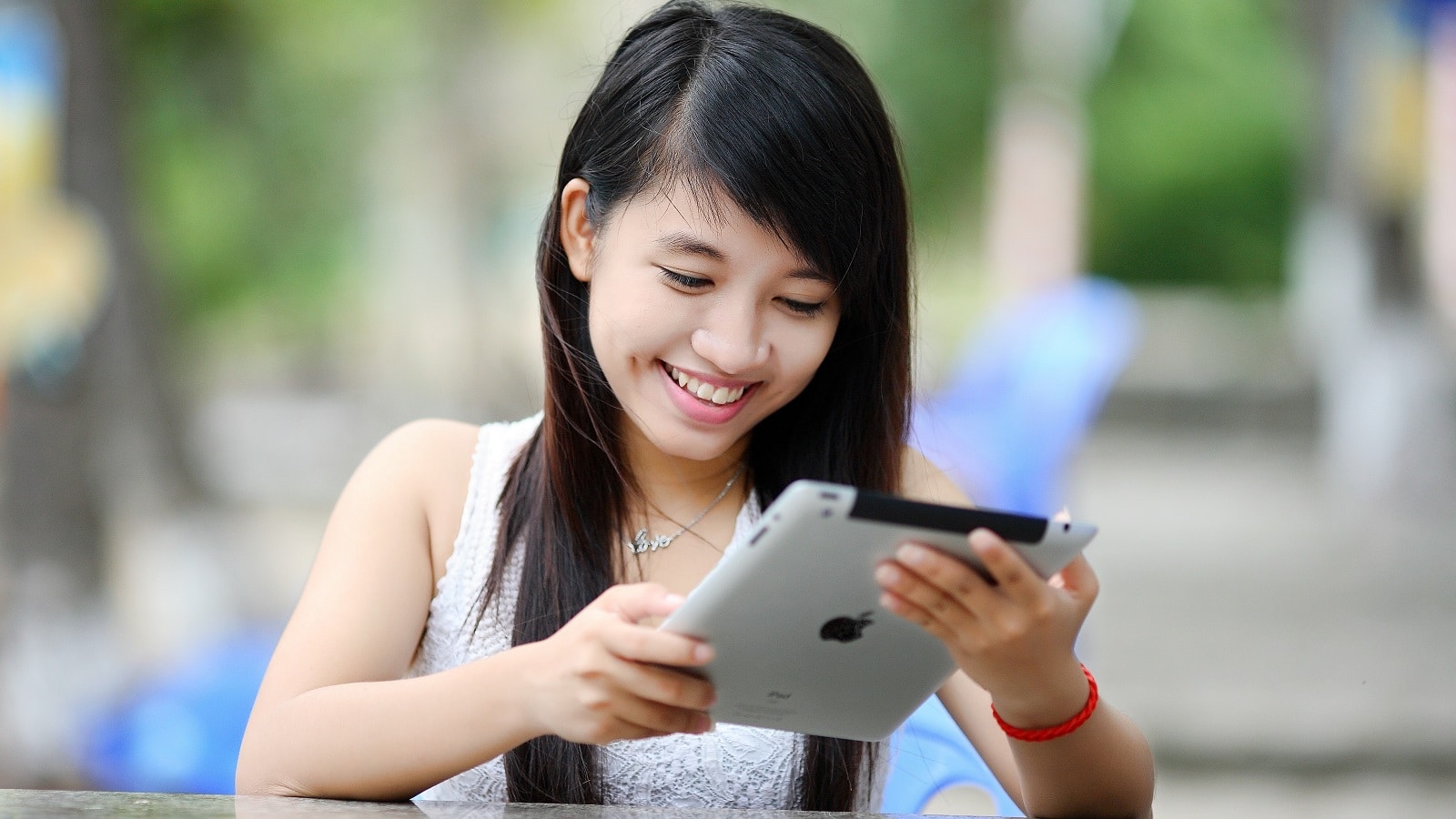 Girl smiling looking at iPad