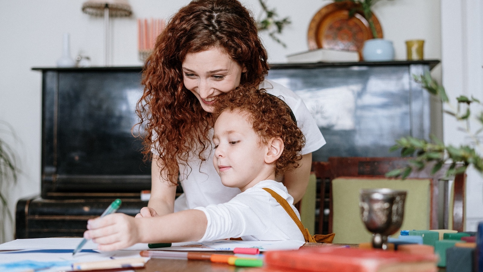 Mother and son working on schoolwork