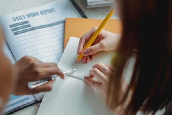 Overhead photo of two women collaborating on a document