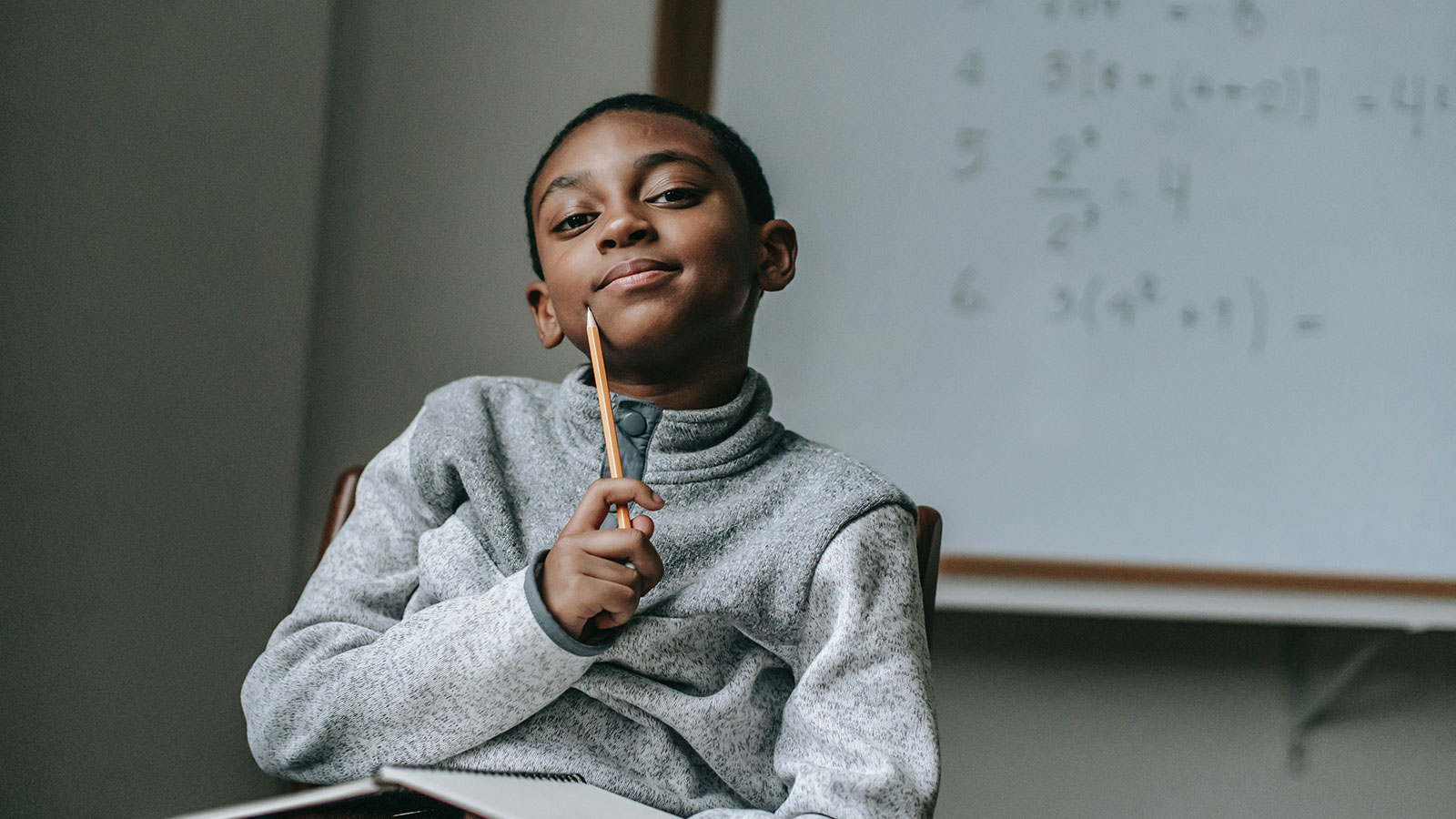 Thoughtful boy with pencil