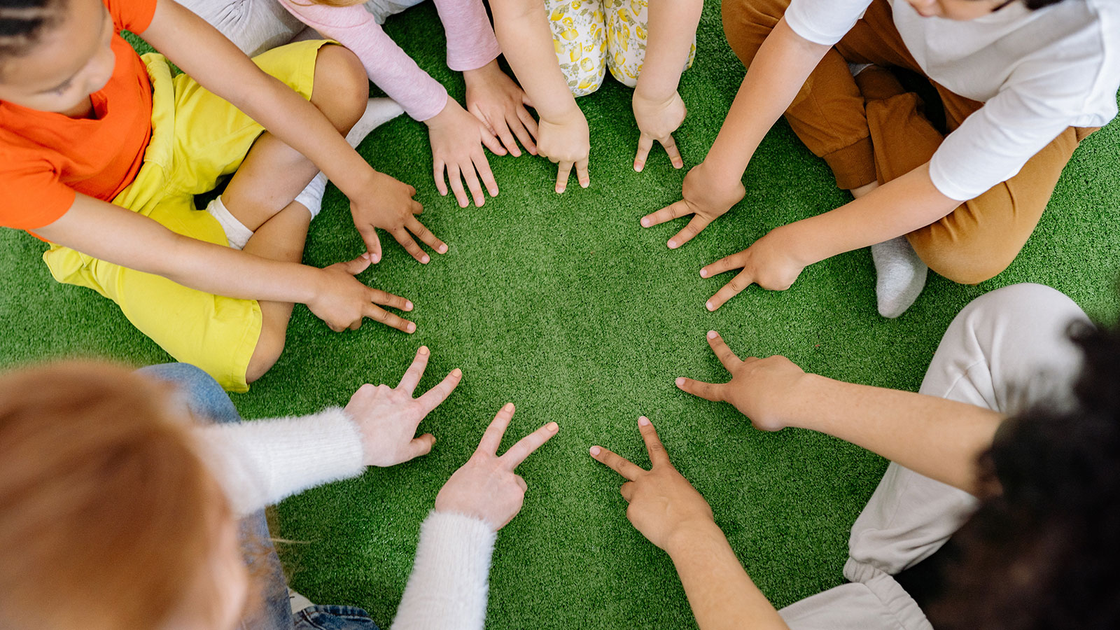 Group of Children Playing on Green Grass