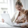 Photo of mom and little girl learning on a laptop