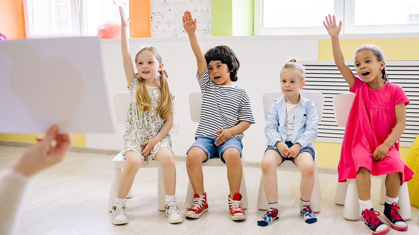 Children Raising Their Hands in a Classroom