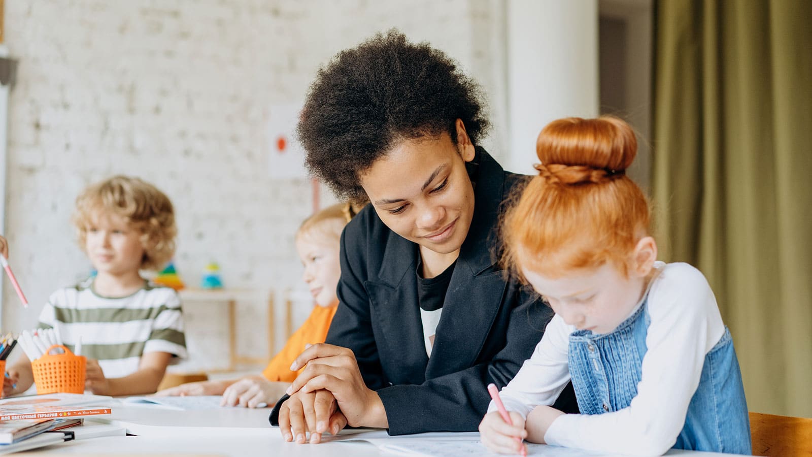 A Girl Writing On A Book Beside A Woman