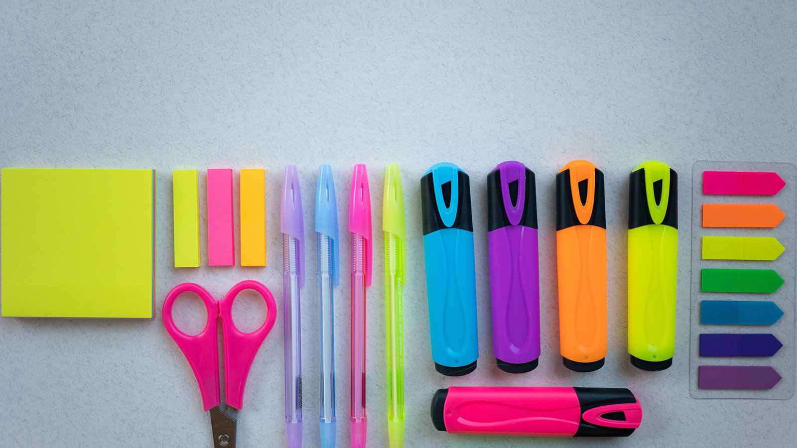 Colorful school supplies on a white surface