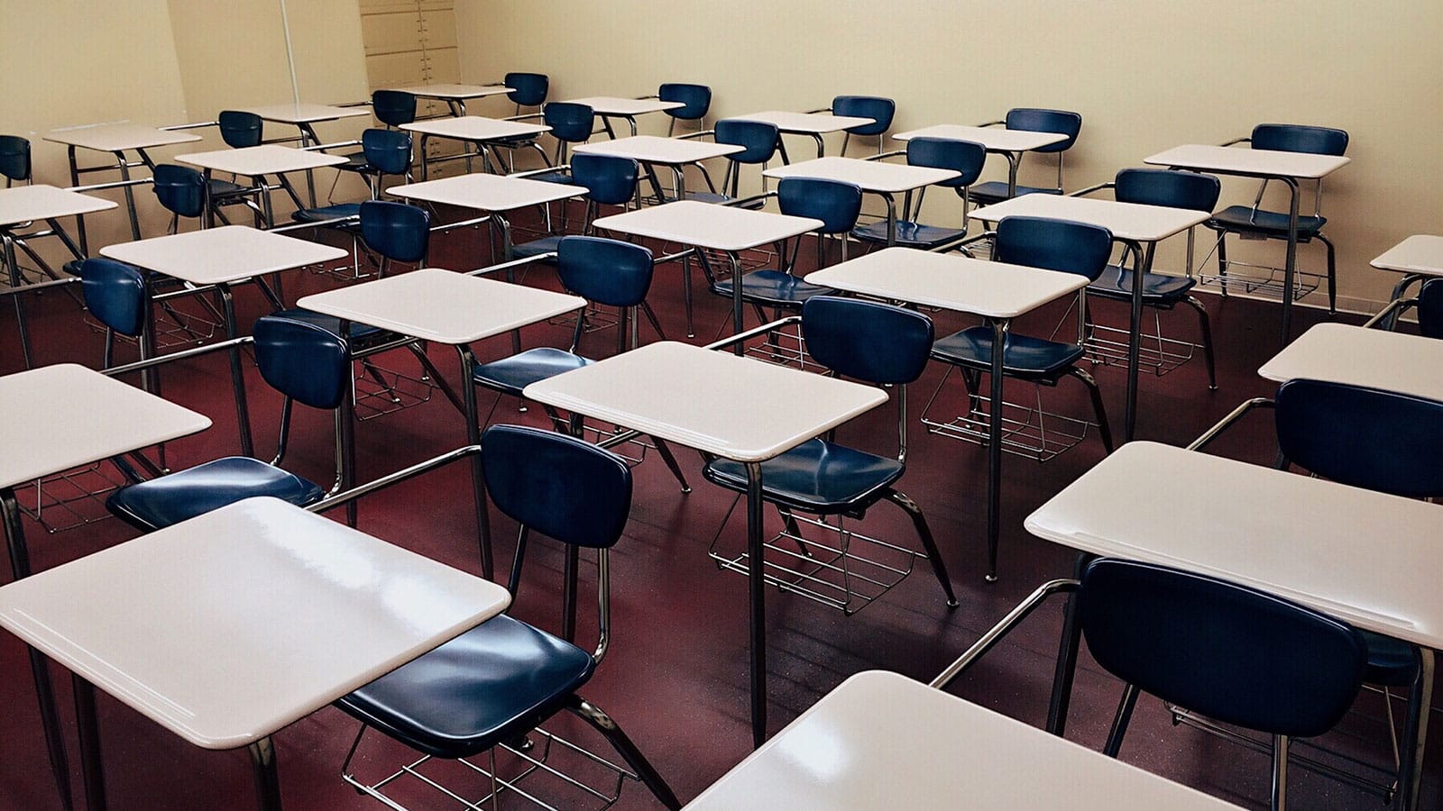 Empty classroom with rows of desks