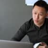 Man in black long sleeved shirt talking to a woman