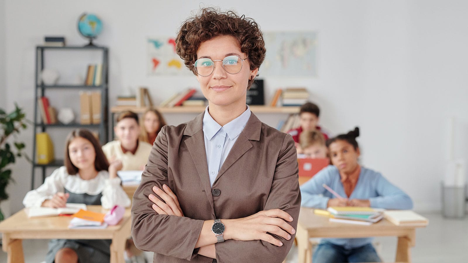 Woman standing in front of students seated at individual desks