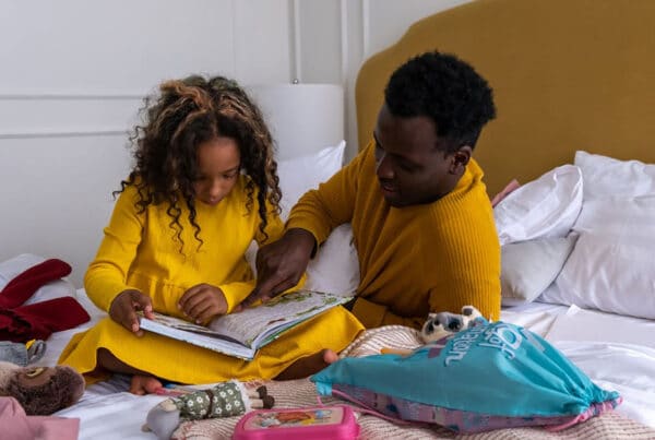 A male and female student studying together from a textbook