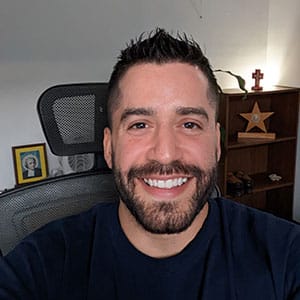 Scholarship winner Andres smiling at a camera while sitting down